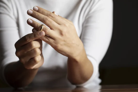 A women removing her wedding ring