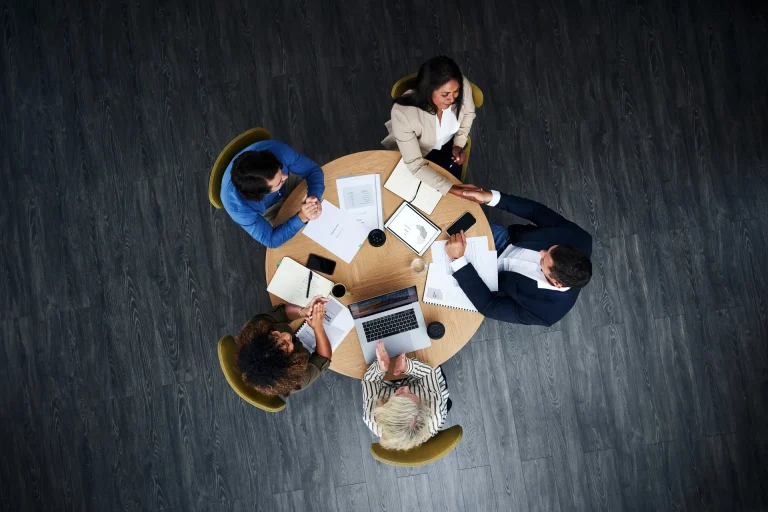 A Soliciting team sat around a table from above