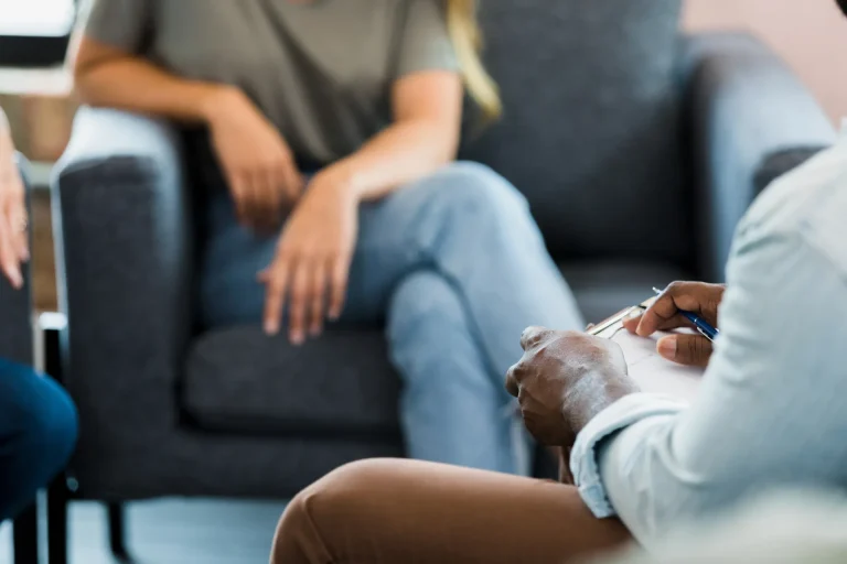 A young women talking to her Solicitor in a relaxed environment while the Solicitor takes notes