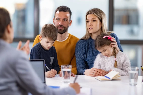 A concerned looking family talking to a Solicitor