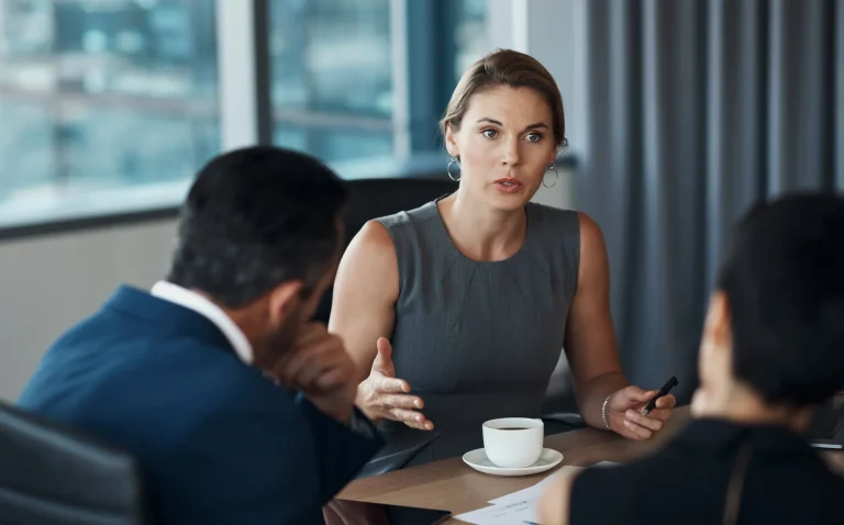 A solicitor in discussion with her clients in an office environment