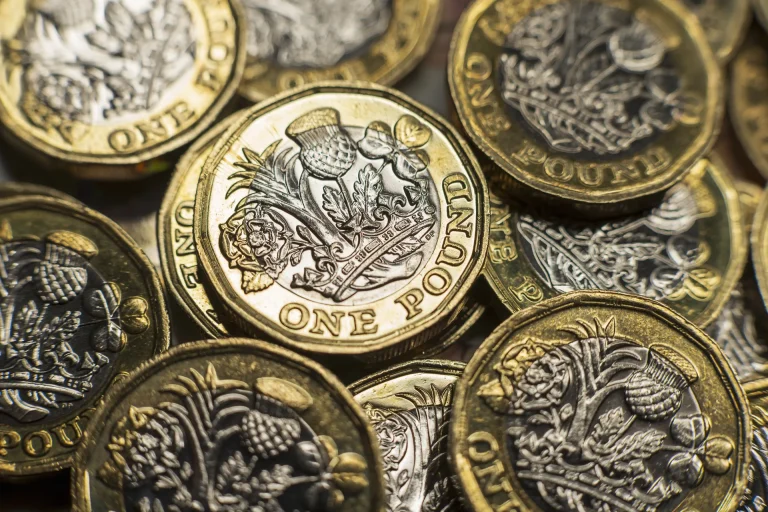 A close-up photograph of one pound coins