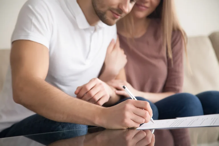 A couple signing legal documents